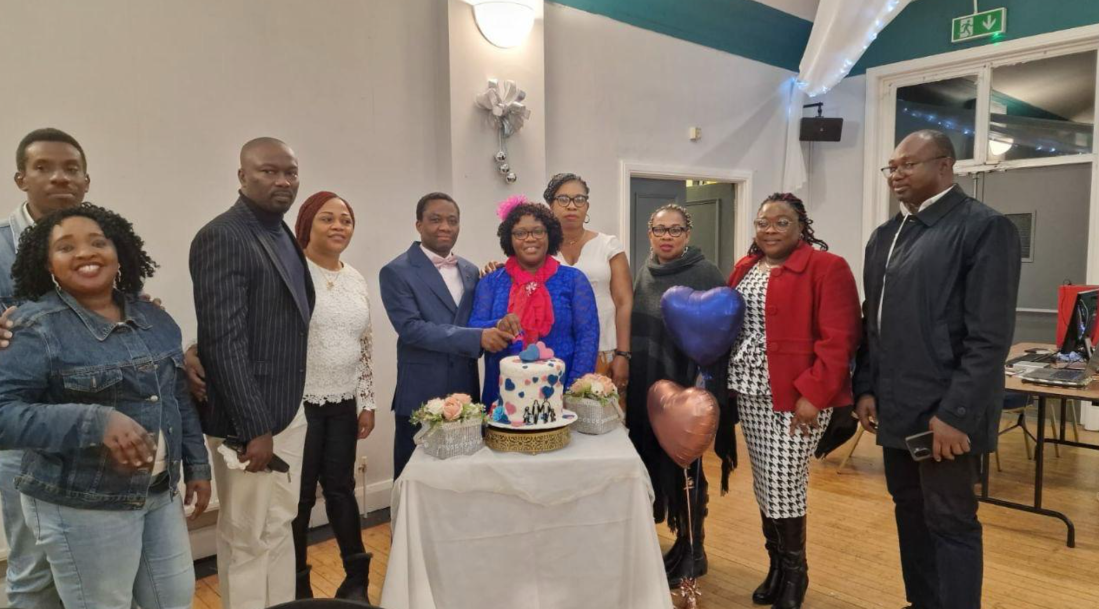 Ministry family cutting a celebration cake together