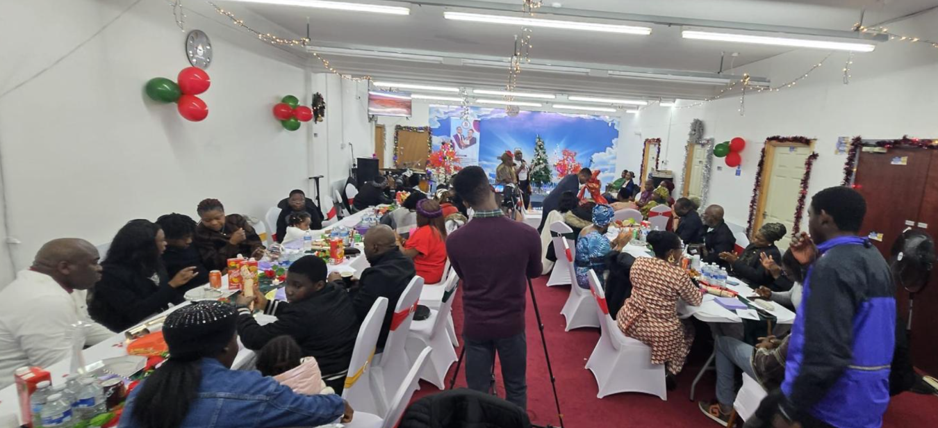 Guests seated for a fellowship meal at the community hall